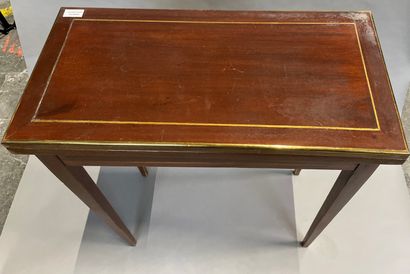 null A mahogany veneered game table with brass fillets, opens to a side drawer.

19th...