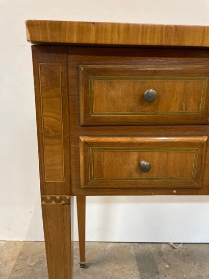 null Veneered chest of drawers inlaid with green tinted fillets, the top opening...