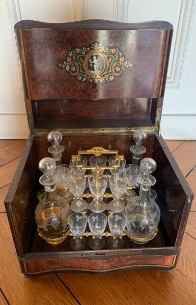 null 
A liquor cabinet with four bottles and sixteen glasses in a burl veneer case...