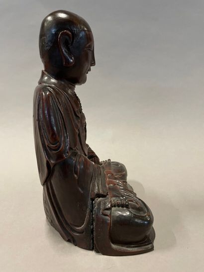 null Bodhisattva in patinated wood and red lacquered representing a monk in meditation.

China,...