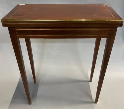 null A mahogany veneered game table with brass fillets, opens to a side drawer.

19th...