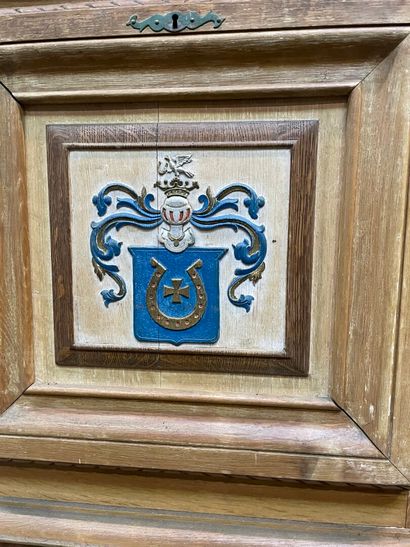 null Cabinet in moulded ceruse oak, opening with a flap painted with the coat of...