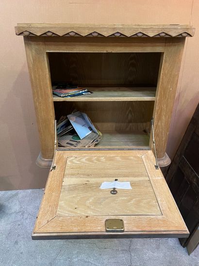 null Cabinet in moulded ceruse oak, opening with a flap painted with the coat of...