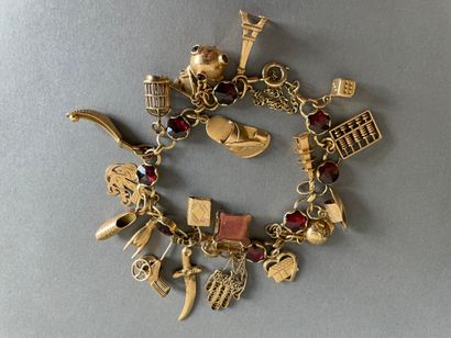 null Bracelet line of nine rose-cut garnets, supporting 21 pendants mostly in 18K...