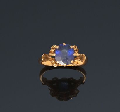 null Ring decorated with a sapphire, yellow gold wire setting with scroll decoration.

Weight...