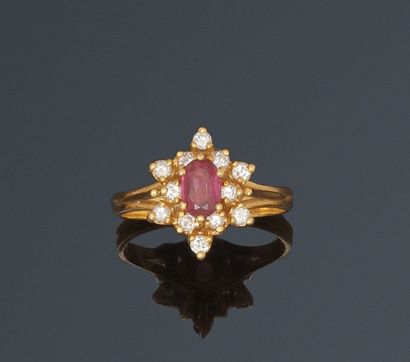 null Ring decorated with an oval ruby in a double circle of diamonds. 

Yellow gold...
