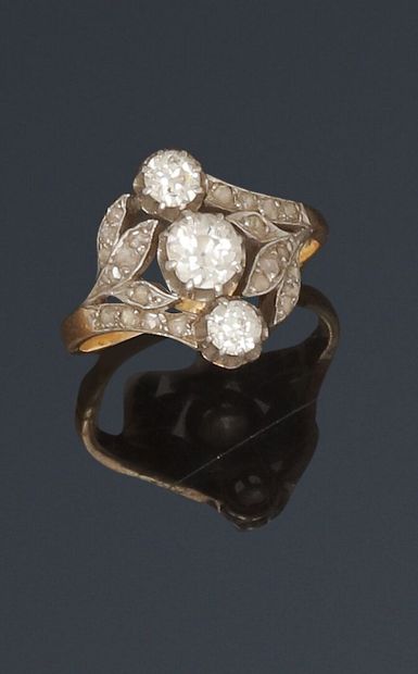 Antique ring set with a line of three diamonds...