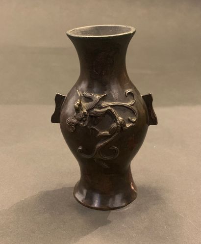 null CHINA - 19th century

Small bronze vase with relief decoration on the body of...