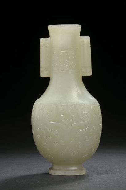 null CHINA - 18th century

Small nephrite vase carved with archaic decoration in...