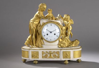 null White marble clock, the dial embedded in a column flanked by a young woman,...