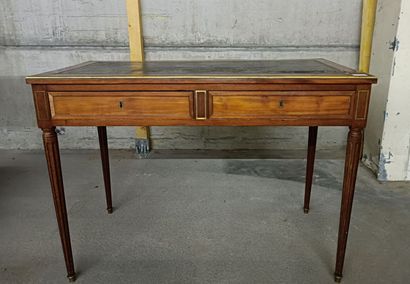 null Mahogany veneered writing table, the belt opening to two drawers in belt with...