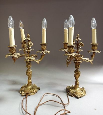 null Pair of ormolu torches, the shaft and the three arms of lights foliage. 

Louis...