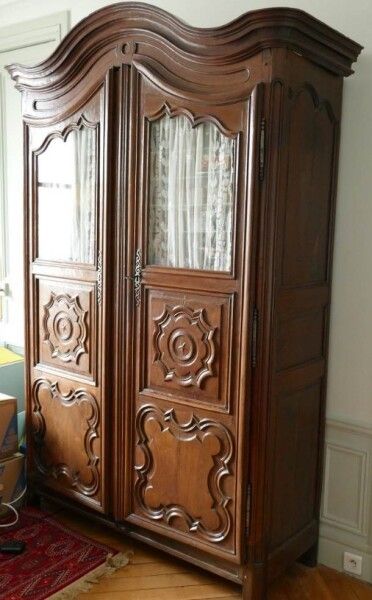 null Cupboard with two partially glazed doors in molded natural wood. 

Provincial...