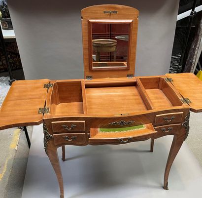 null Dressing table in wood veneer opening to three flaps a shelf and a drawer, cambered...
