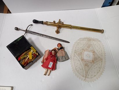 null Two small dolls, a brass scientific instrument, a set of game tokens, a small...