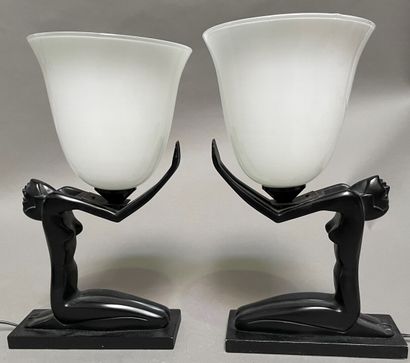 Pair of lamp bases representing a kneeling...