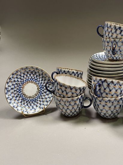 null Two parts of porcelain tea services:

-One Russian with blue and gold trellis...