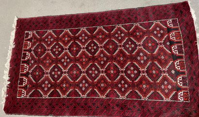 
Wool carpet with burgundy background decorated...