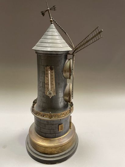 null Clock forming a mill in brass and pewter containing a barometer and a thermometer...