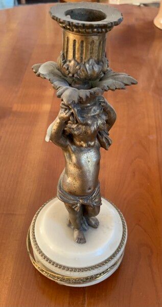 null Bronze and alabaster mantelpiece including a clock decorated with two cherubs...