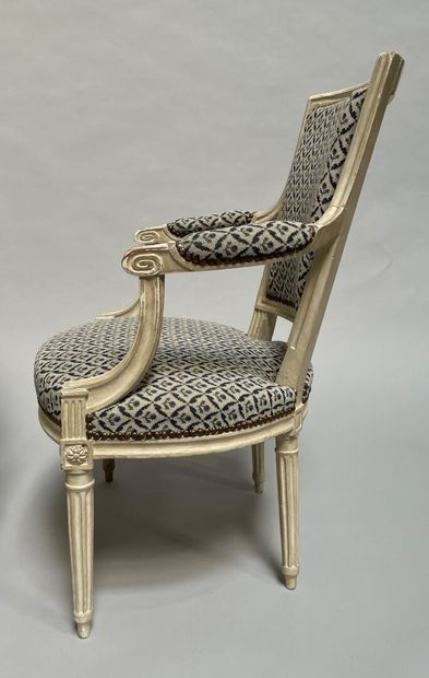 null Four armchairs in molded and carved wood, white lacquered, cabriolet back, tapered...