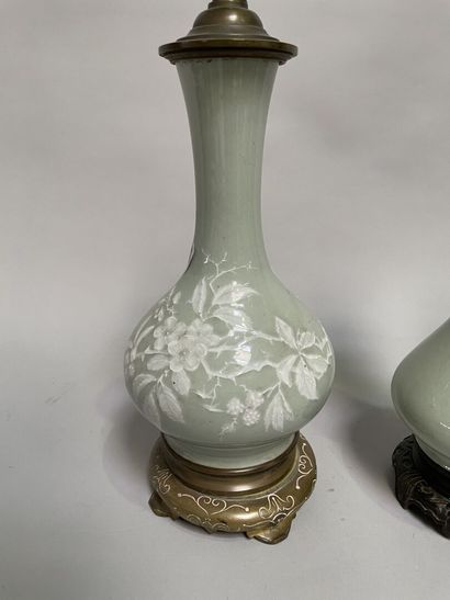 null Pair of celadon porcelain oil lamp and lamp base with white flowers in relief,...