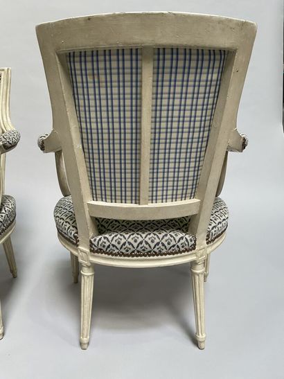 null Four armchairs in molded and carved wood, white lacquered, cabriolet back, tapered...