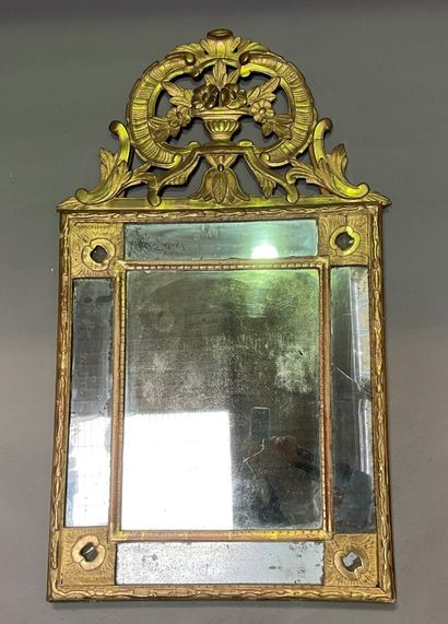null Wood and gilded stucco mirror with parecloses, the pediment in wood carved with...