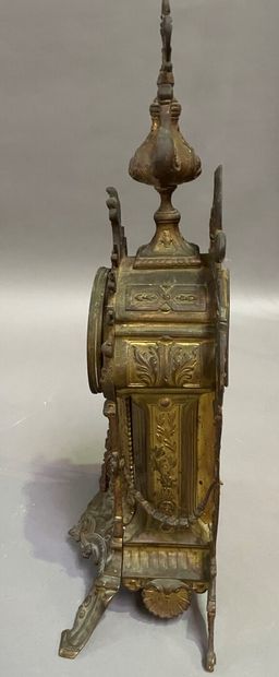null Gilded bronze clock of architectural form, the dial under an arch topped by...