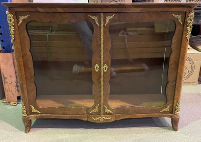 null Rosewood veneer display cabinet with two doors, gilt bronze ornaments.

Louis...