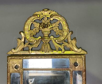 null Wood and gilded stucco mirror with parecloses, the pediment in wood carved with...