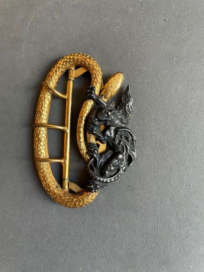 
Belt buckle in gilt bronze and black patina...