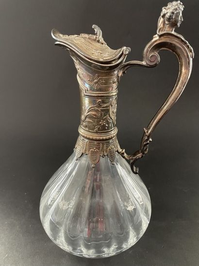 null 
Glass ewer with twisted ribs mounted silver chased with foliage, the handle...