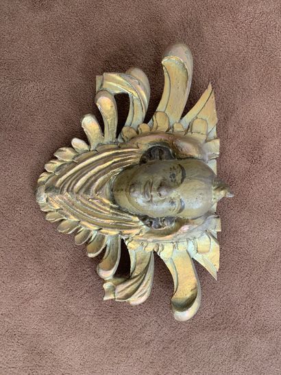 
Element in carved wood with a draped and...