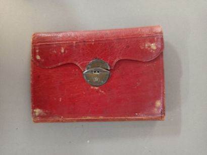 null 
Small red leather wallet with long grains, decorated with an oval medallion...