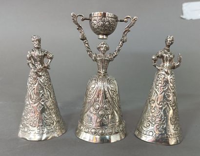 
Three cups in the shape of a woman in silver....