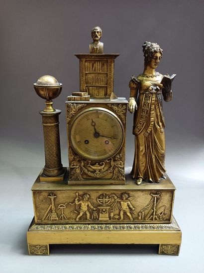 
Gilt bronze clock with a library, flanked...