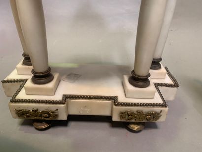 null 
Marble mantel set including a portico clock and a pair of cassolettes. The...