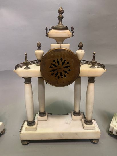 null 
Marble mantel set including a portico clock and a pair of cassolettes. The...