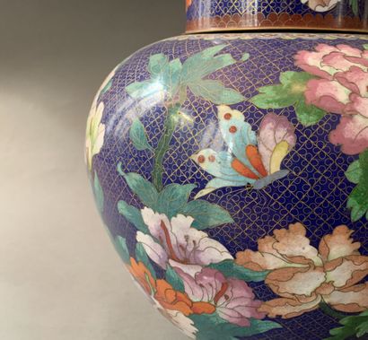 null Pair of cloisonné enamel covered vases decorated with flowers, birds and butterflies.

China,...