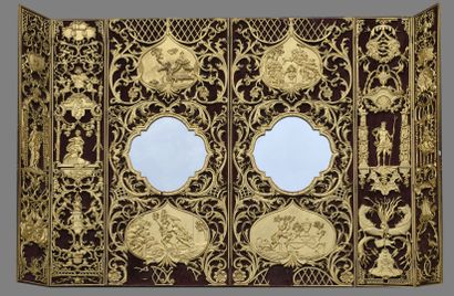 null Curious screen in six unequal leaves with rich openwork, gilded and carved decoration...
