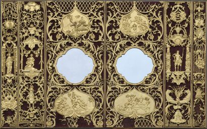 null Curious screen in six unequal leaves with rich openwork, gilded and carved decoration...