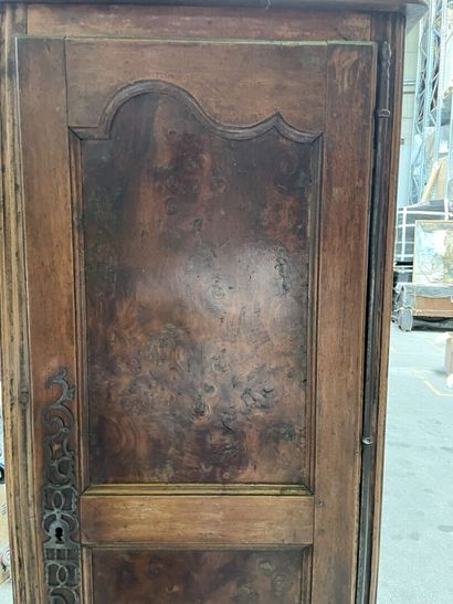 null Bonnetiere in molded and stained wood opening to a door and a drawer, feet avan...