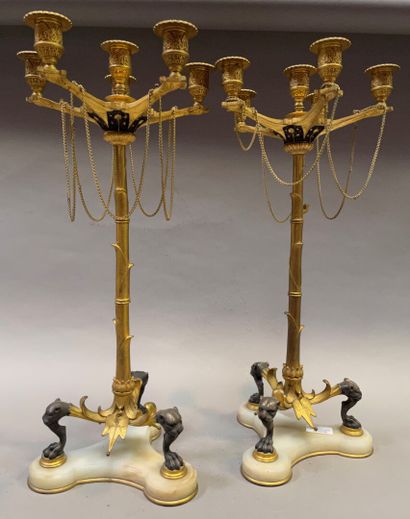 null Pair of candelabras with six lights, the shaft in the shape of palm in gilt...