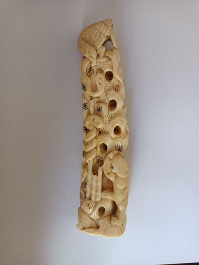 null Two subjects in ivory.

The first one shows a group of turtles climbing a rock...