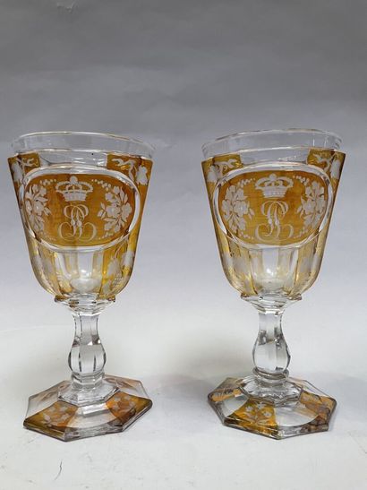 Two glasses out of yellow doubled glass engraved...