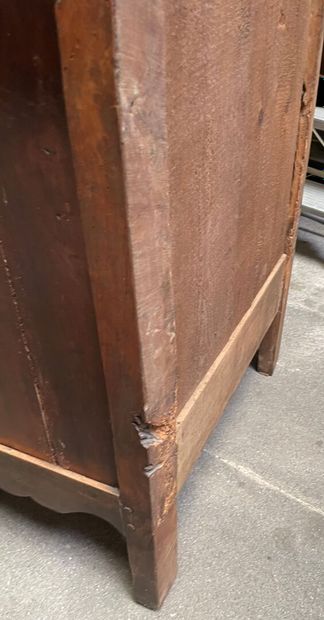 null Bonnetiere in molded and stained wood opening to a door and a drawer, feet avan...