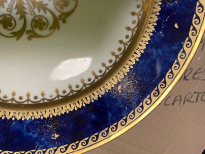 null Plate in porcelain of Sevres with marbled blue bottom with decoration in gilding...