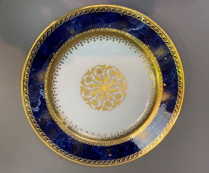 null Plate in porcelain of Sevres with marbled blue bottom with decoration in gilding...