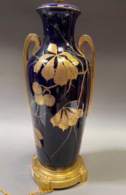 null Important porcelain vase decorated on a blue background with a gilded chestnut...